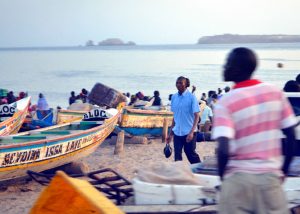 In the early evenings, people gather at key spots on the beach in Dakar to buy fish straight off the small, colorful fishing boats.